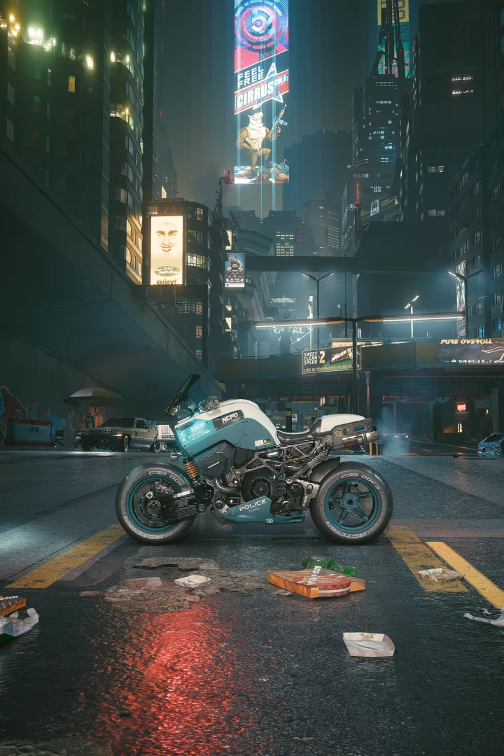 A riderless Brennan Apollo parked side-on in a littered street at night, a red reflection on the wet asphalt