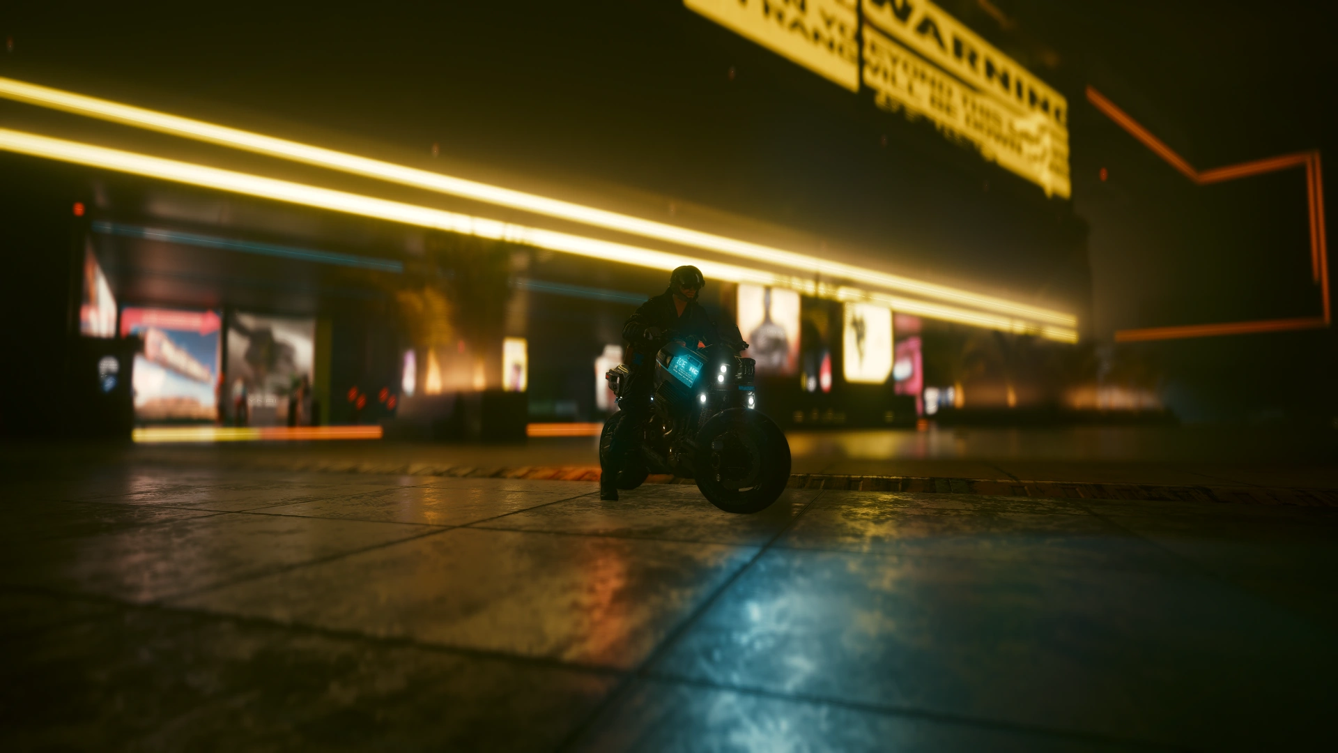 A police motorcycle riding towards the camera past a shopfront lit by long yellow neon strips
