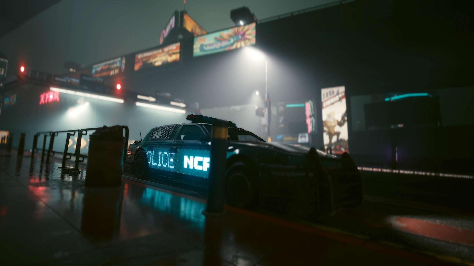 A patrol car in fog beneath overhead billboards, its side sign lit cyan