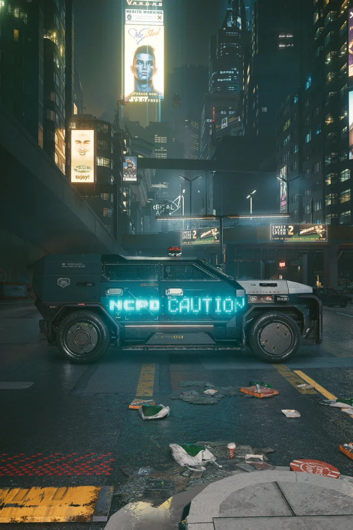 A Chevalier Emperor side-on across a litter-strewn street at night, NCPD CAUTION glowing cyan along its side, towers and billboards above